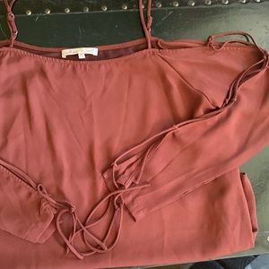 Burgundy long sleeve blouse with tied arms.